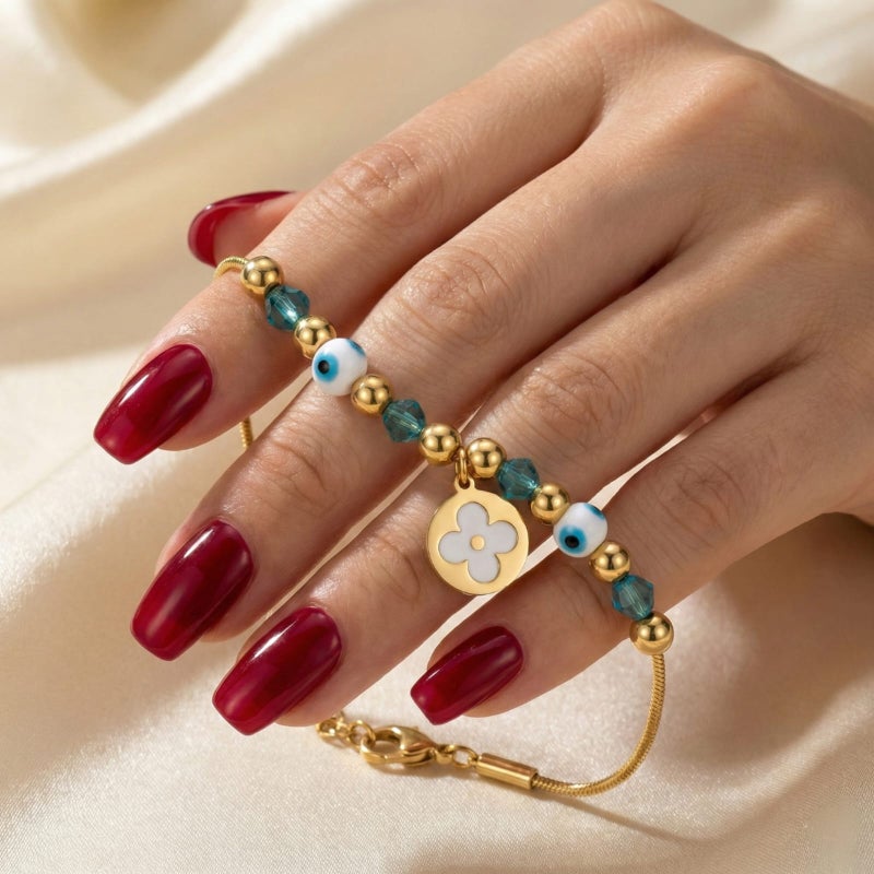 A gold bracelet made of rust-resistant stainless steel, with a thin design adorned with gold and turquoise beads and an elegant eye shape with a white rose pendant, with an adjustable clasp to fit you. - Image 3
